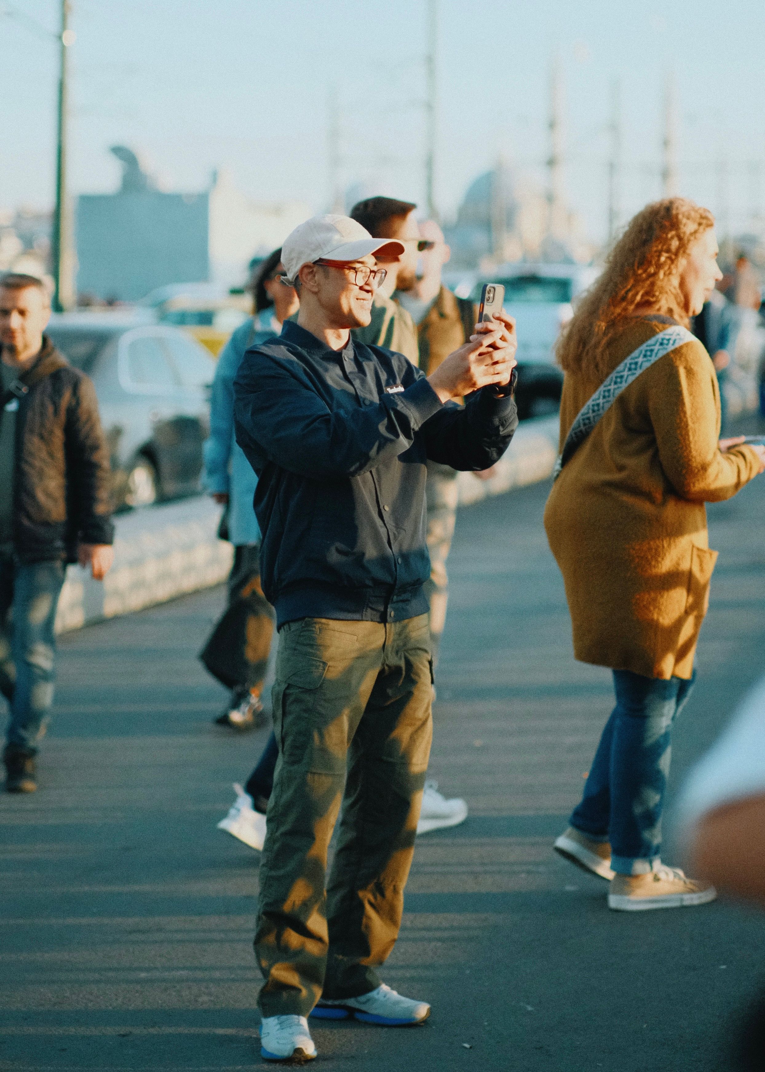 A person taking photos of a local landmark with a smartphone