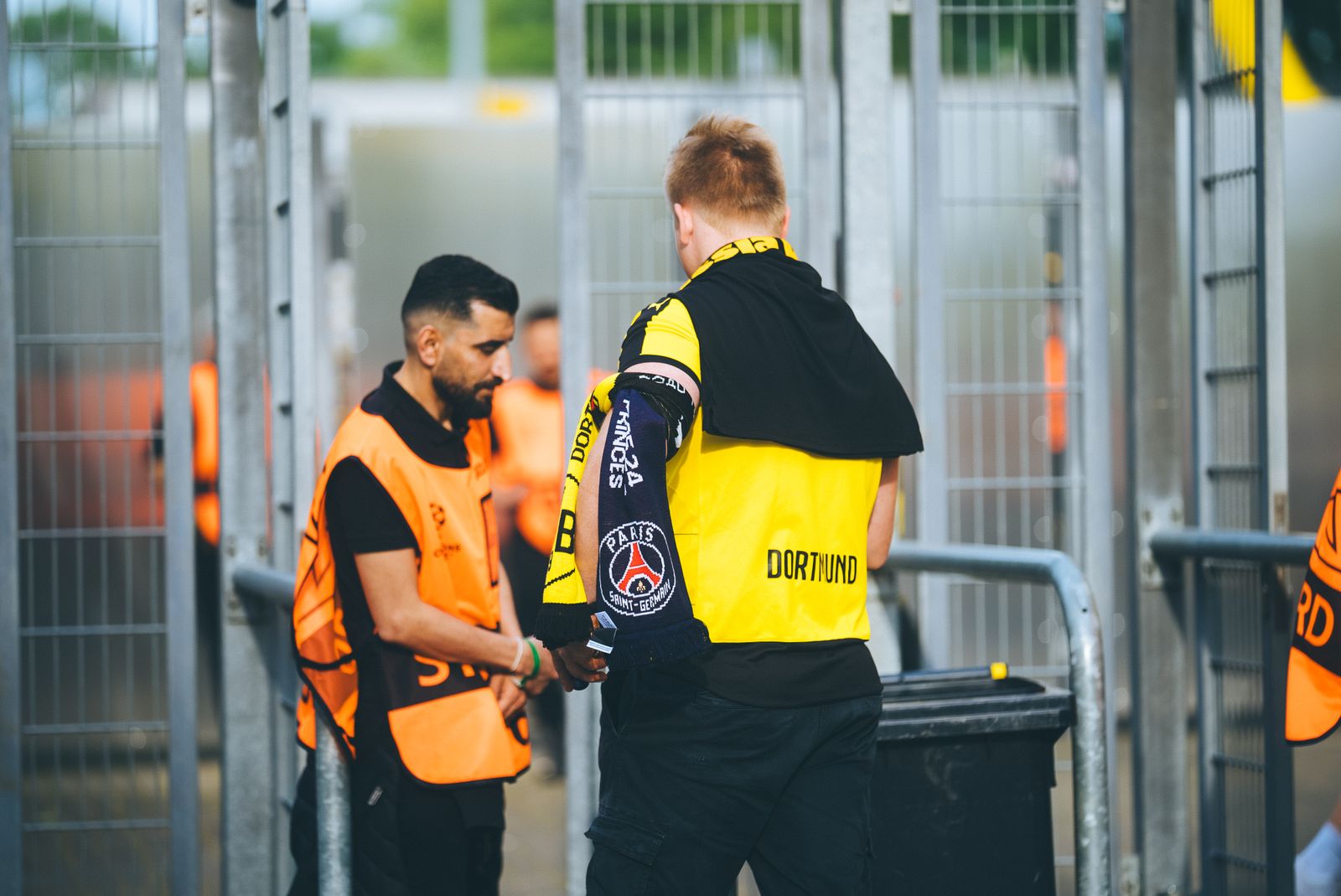 Venue security steward checking a guest at the stadium gate