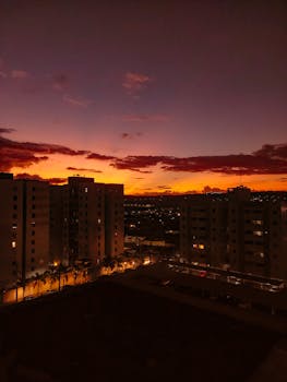 Vibrant sunset over city buildings in Campina Grande, Brazil, capturing the golden and dramatic sky.