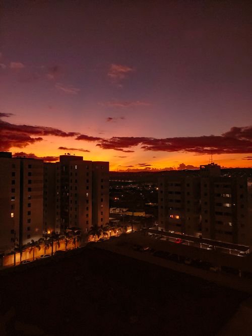Free Vibrant sunset over city buildings in Campina Grande, Brazil, capturing the golden and dramatic sky. Stock Photo