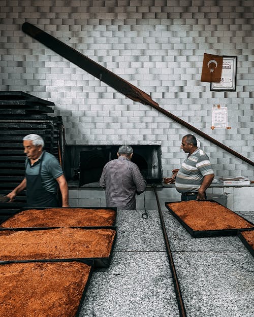 Two men are working in a bakery