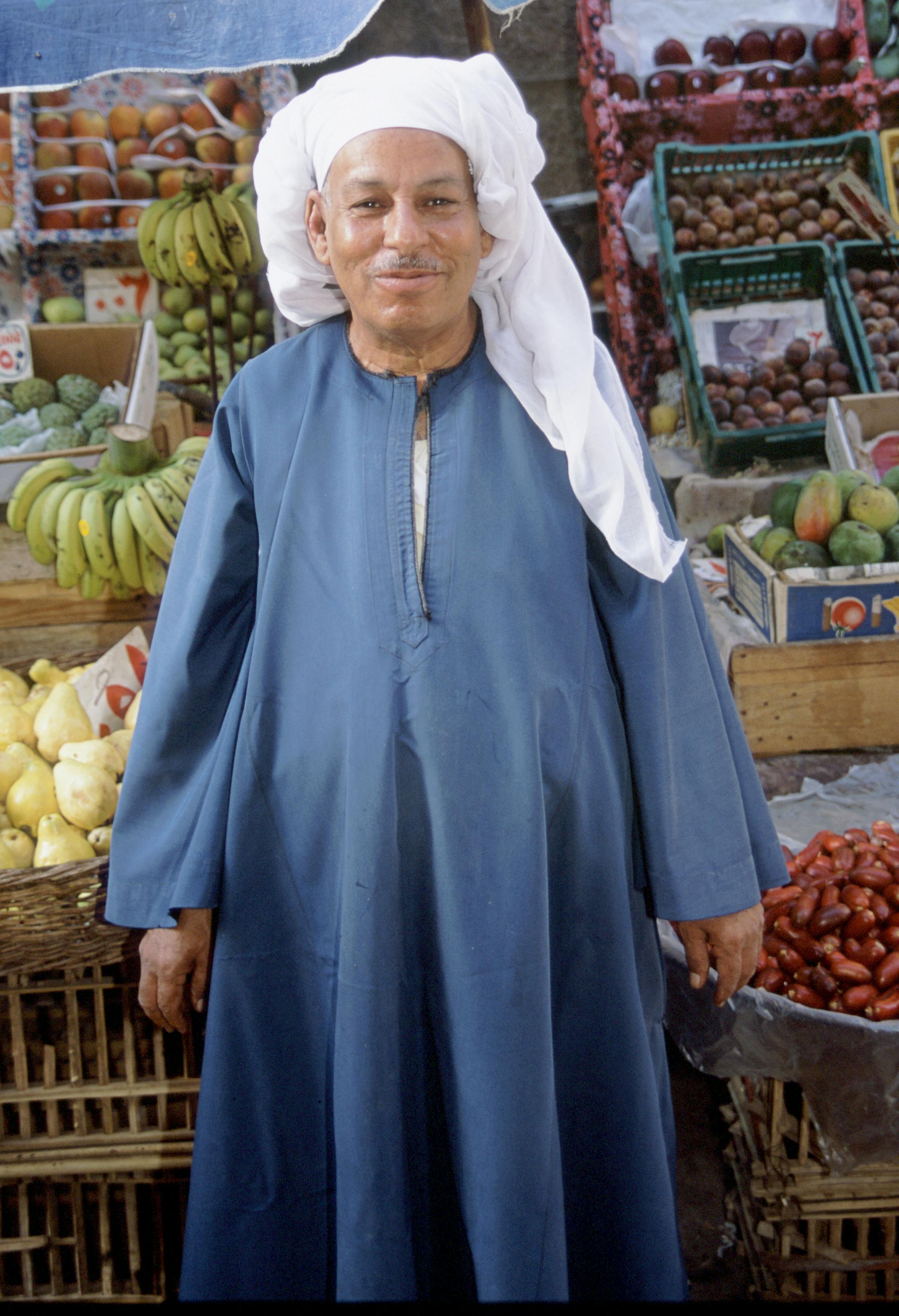 man standing in front of fruits