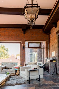 Stylish living room featuring industrial design, large windows, and cozy seating area.