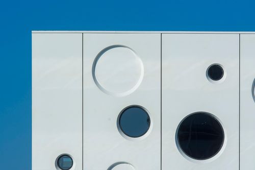 Free Close-up of a futuristic modern white facade with circular windows in Gouda, Netherlands. Stock Photo