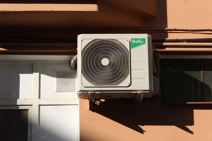 Air conditioner condenser unit on a building exterior