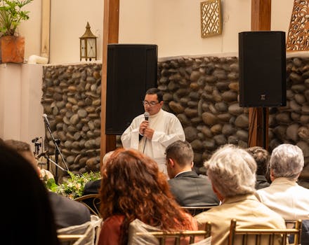 Priest conducting a wedding ceremony indoors in Cuenca, Ecuador.