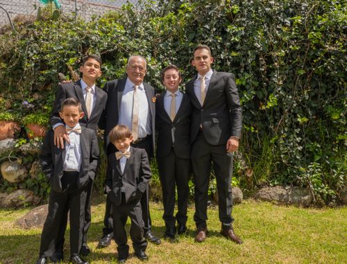 Free Formal family portrait of men in suits outdoors, capturing a memorable family gathering. Stock Photo