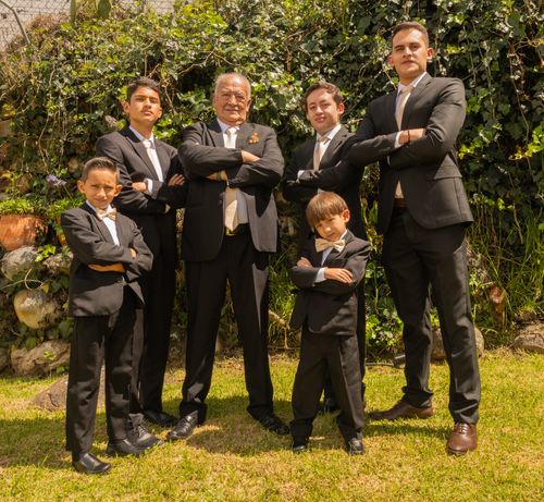 Free A distinguished group of men posing elegantly in suits, captured outdoors in Cuenca, Ecuador. Stock Photo
