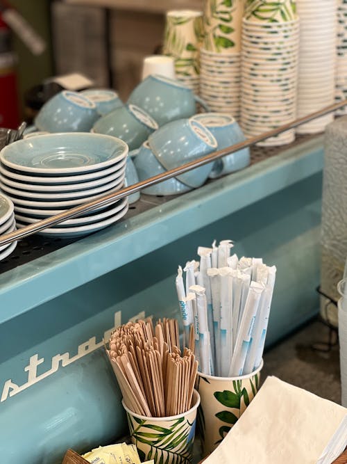 A counter with cups, plates and paper cups