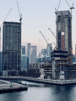 Tall skyscrapers under construction at Dubai Marina, showcasing urban development against the skyline.
