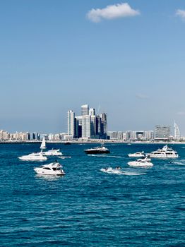 A scenic view of Dubai Marina's skyline and luxurious yachts on tranquil blue waters.