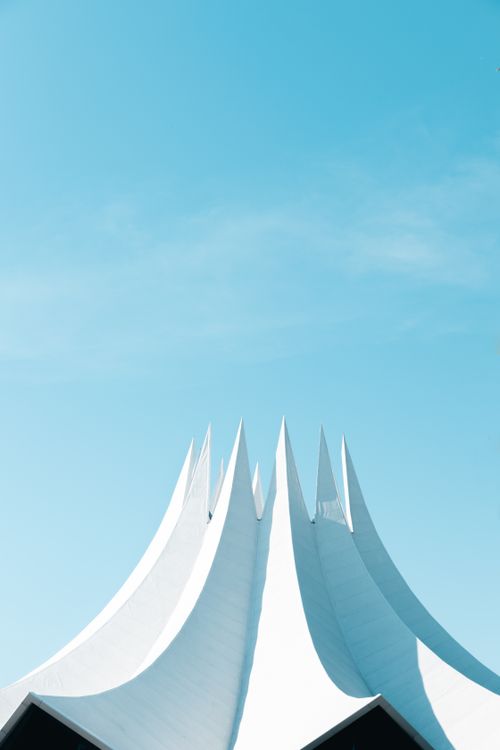 Free A striking vertical shot of Berlin's Tempodrom against a vivid blue sky. Stock Photo