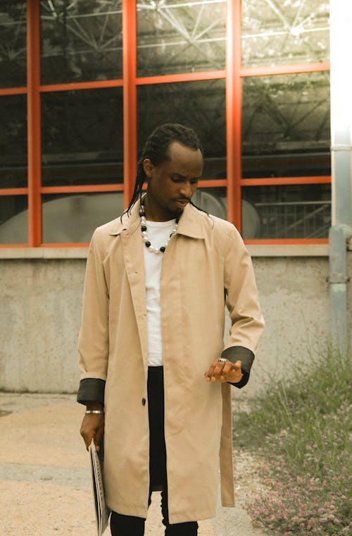 A man in a trench coat and black pants