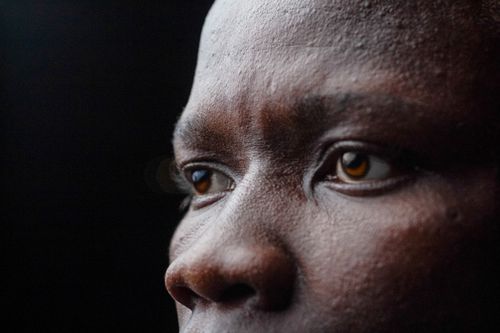 Free A detailed close-up capturing the expression and eyes of a person deep in thought. Stock Photo