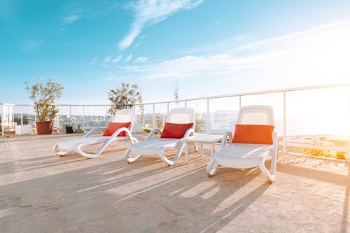 Photo of Three White Deck Chairs Sun loungers