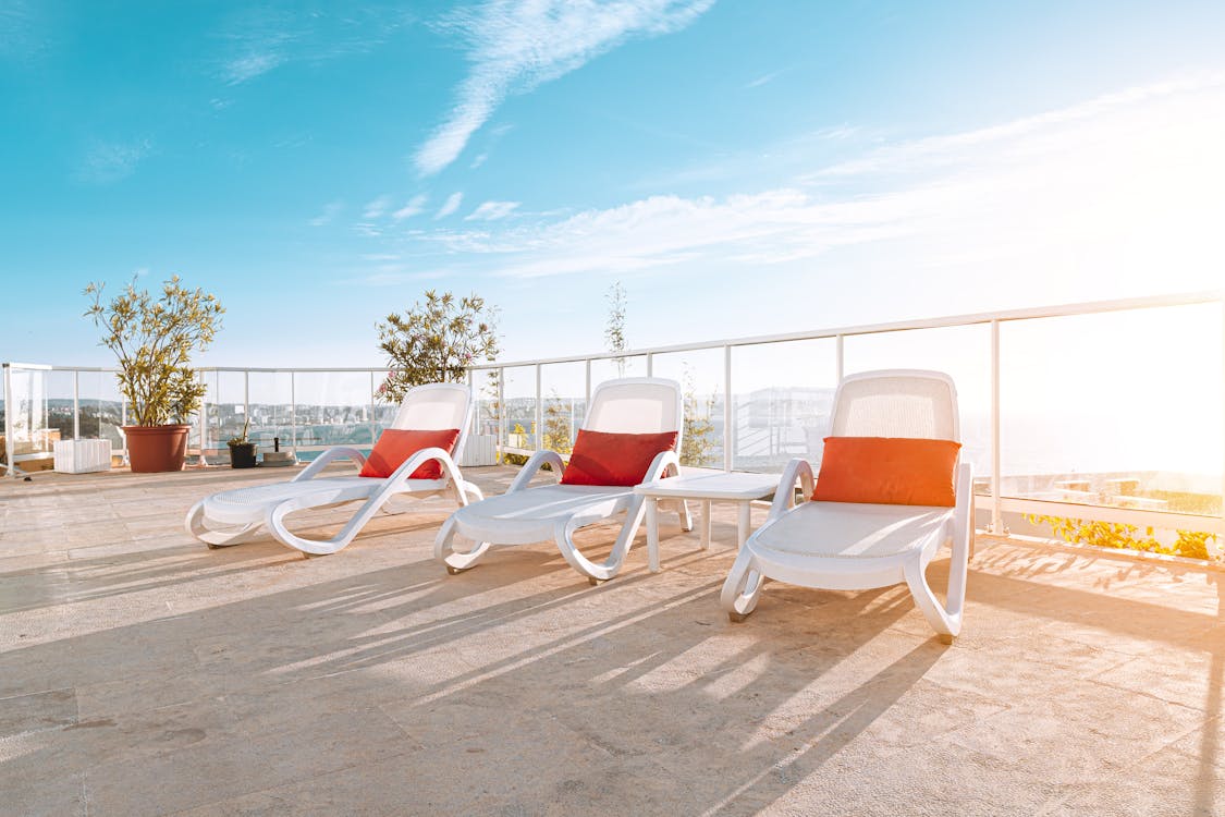 Free Photo of Three White Deck Chairs Sun loungers Stock Photo