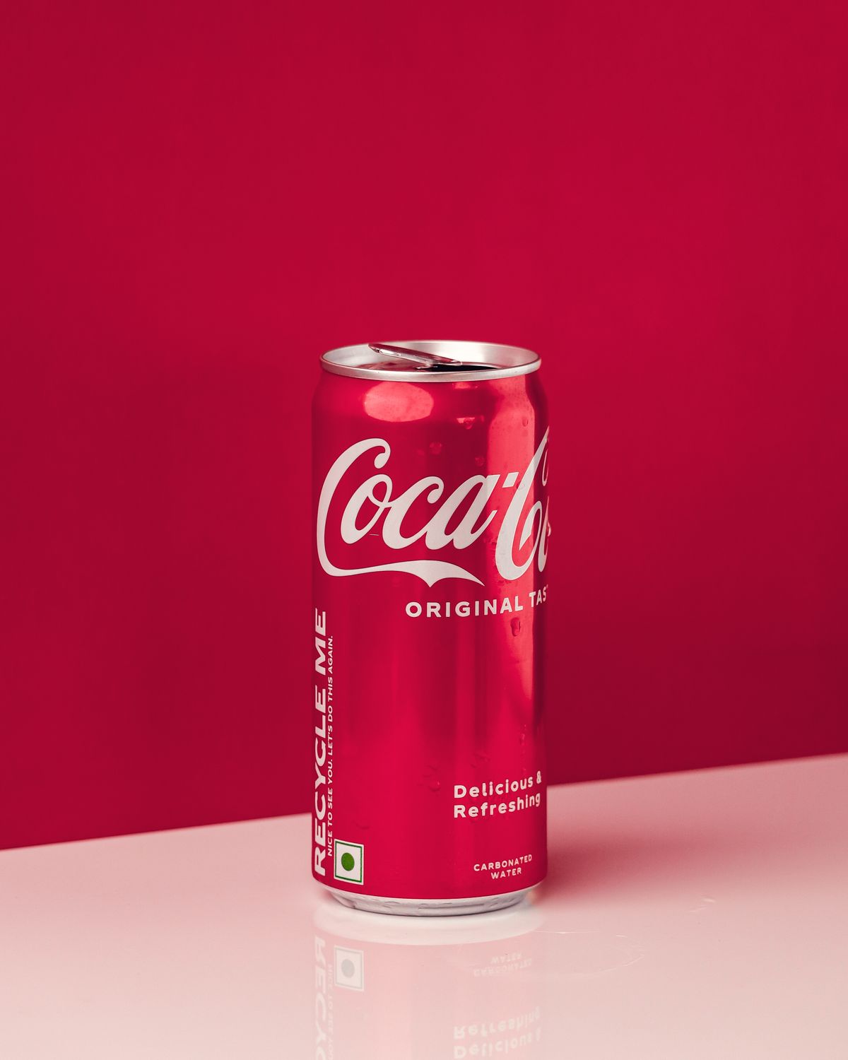 Classic red Coca-Cola can on a red background