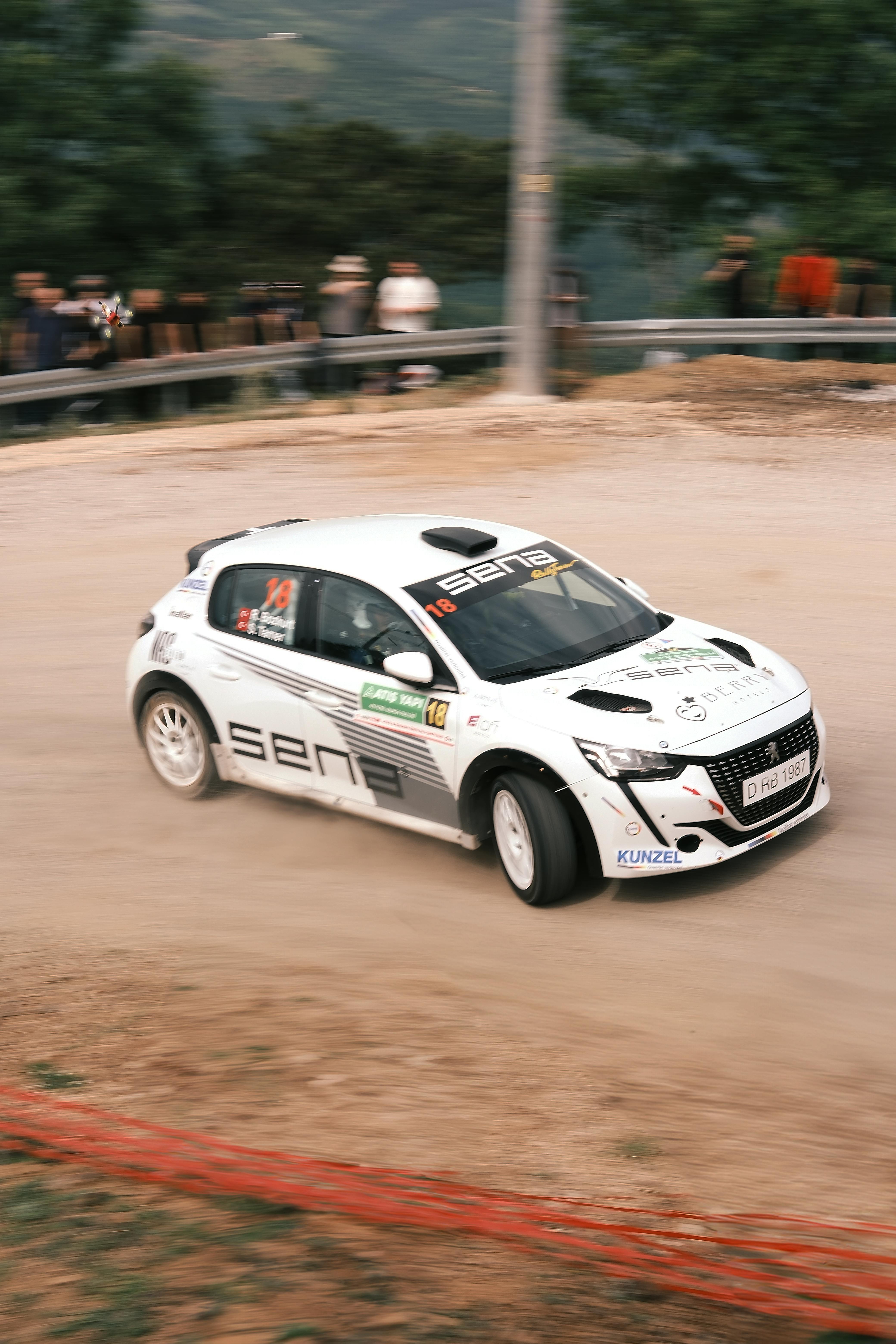 Dynamic rally car skids through dirt track in Bursa, showcasing thrilling automotive action.