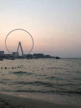 Capture of the Ain Dubai Ferris Wheel at twilight with a serene waterfront view in Dubai, UAE.