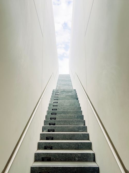 Free Modern minimalist stairway with bright sky beyond, captured in Abu Dhabi's urban setting. Stock Photo