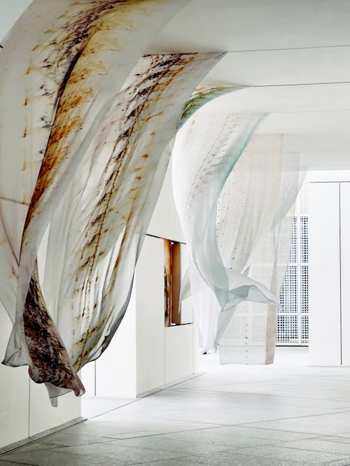 A room with a large hanging fabric hanging from the ceiling