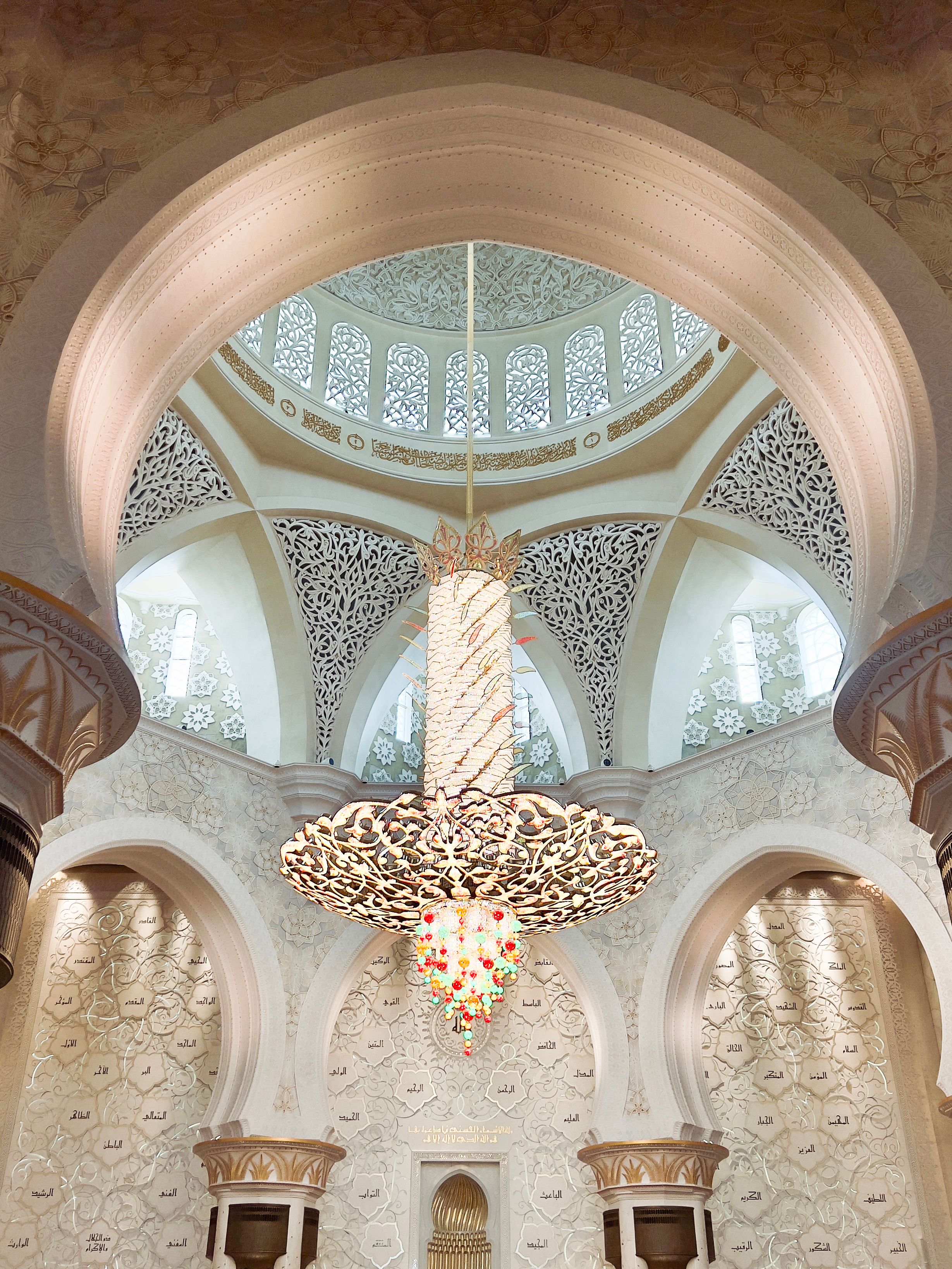 Beautiful interior view of Sheikh Zayed Grand Mosque featuring elegant chandelier and stunning architecture.