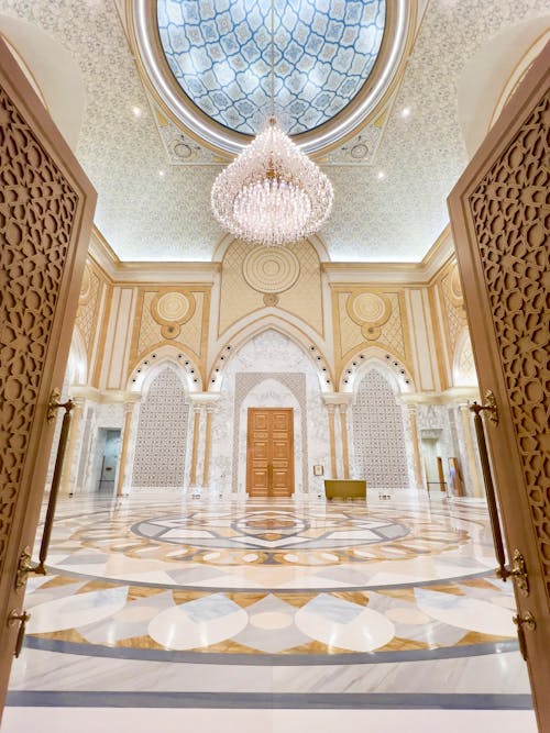 The entrance to a large building with a chandelier