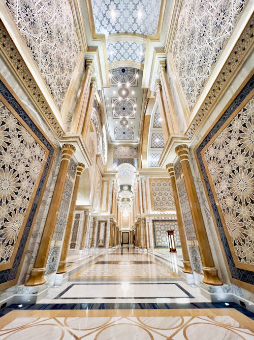 The lobby of a hotel with marble floors and ornate designs