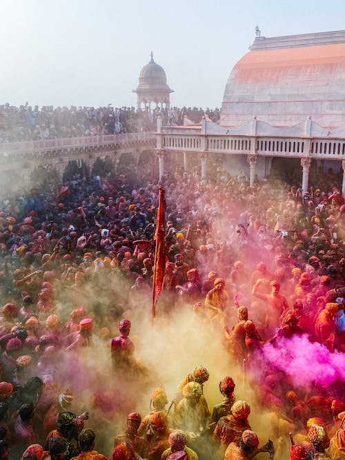 A crowd of people in colorful clothes and powder