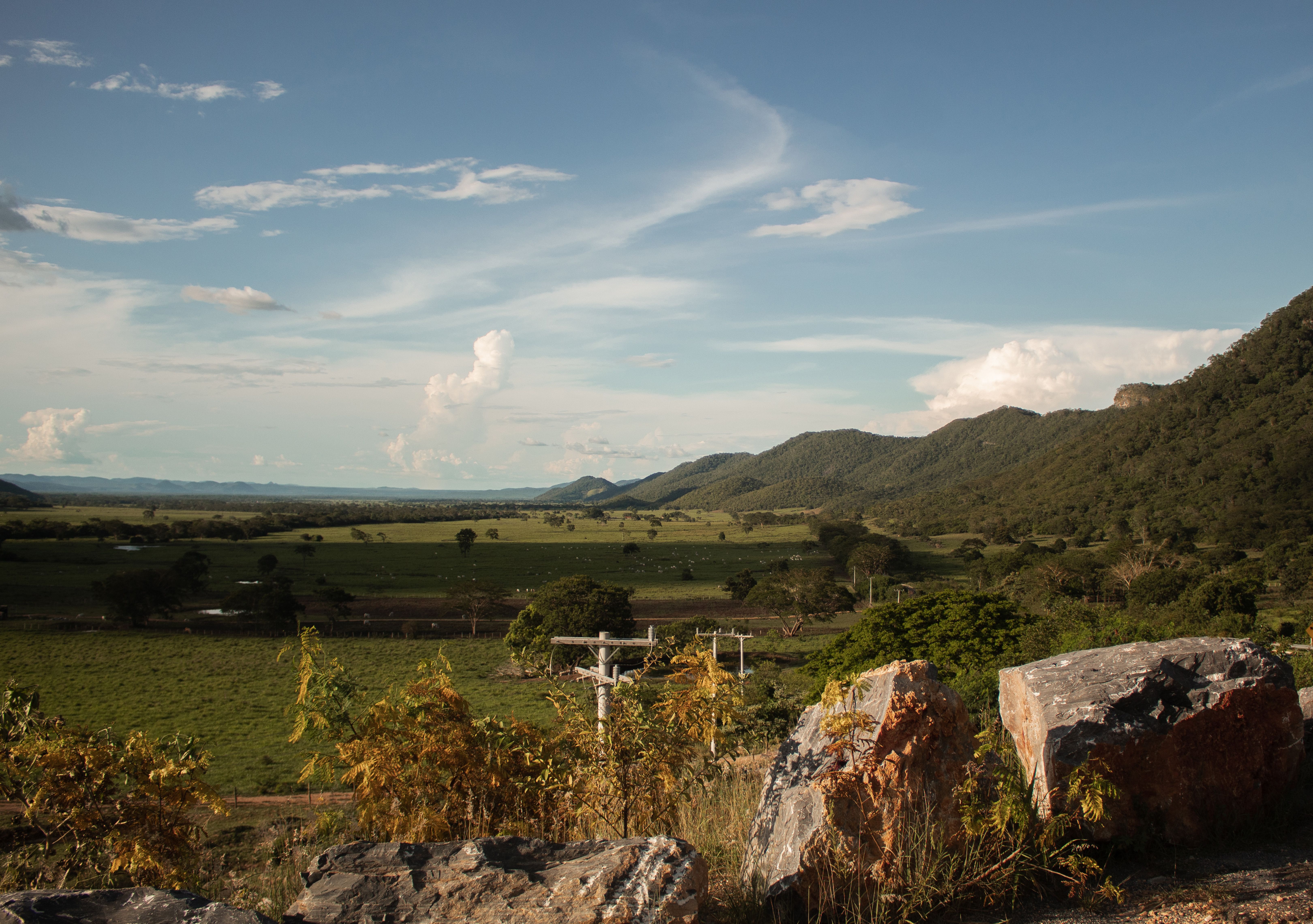 Beautiful rural landscape of fields and mountains in Bonito, Brazil under a clear sky.