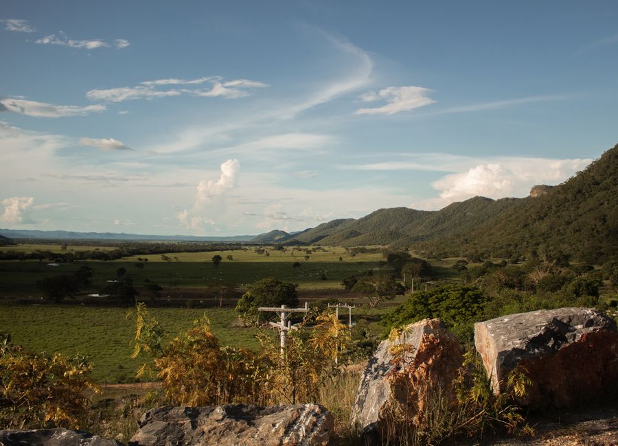 Beautiful rural landscape of fields and mountains in Bonito, Brazil under a clear sky.