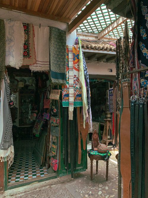 Free Explore a vibrant bazaar showcasing traditional handmade fabrics and shawls. Stock Photo