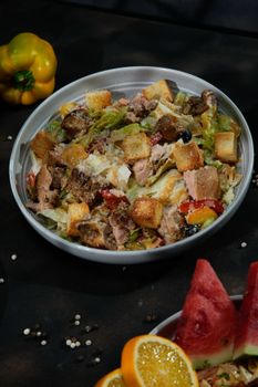 Vibrant grilled chicken Caesar salad with croutons, peppers, and cheese.