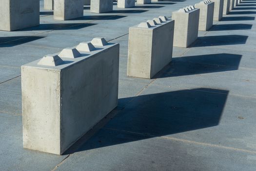 A row of concrete blocks with shadows on them