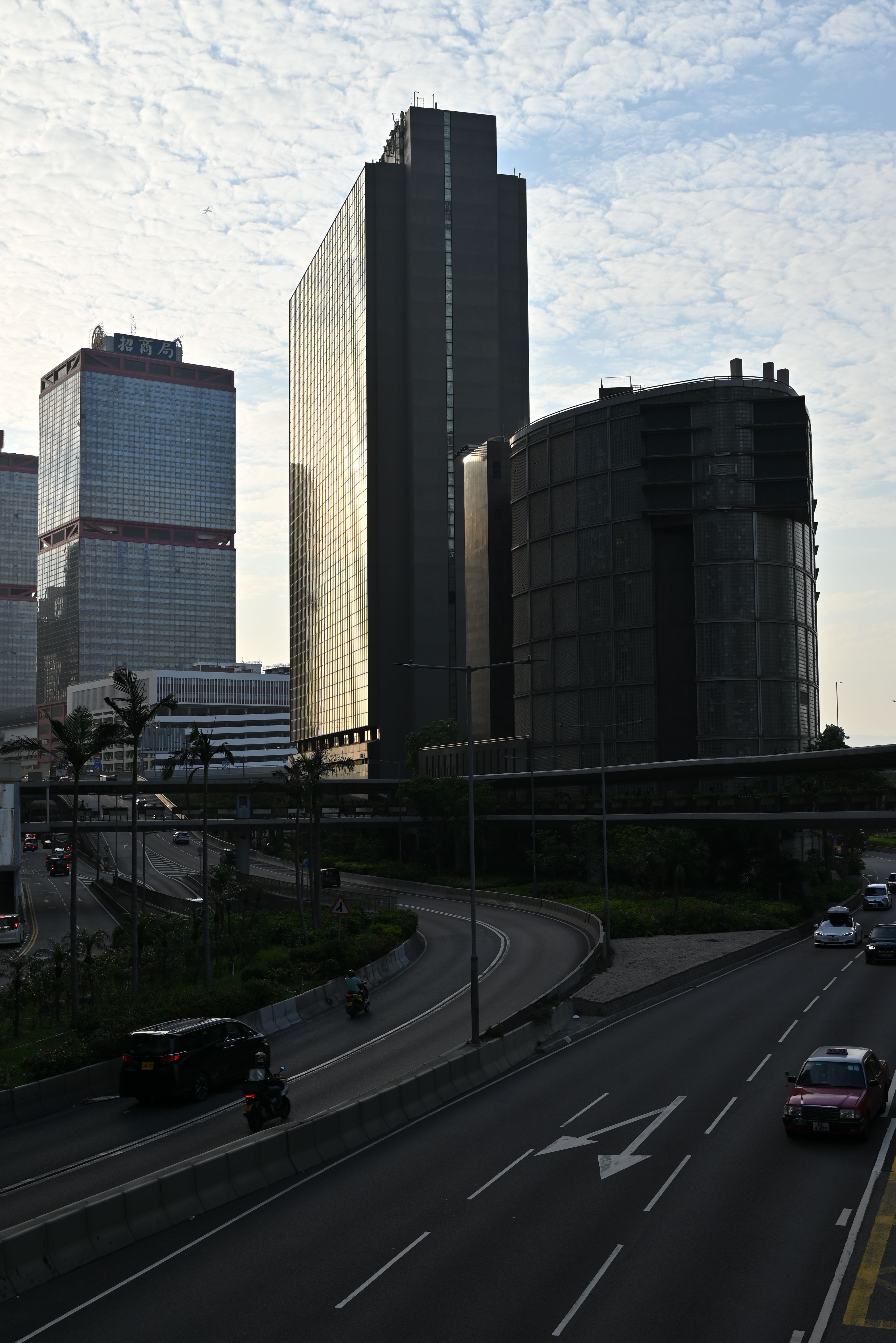 Dynamic view of contemporary skyscrapers and bustling city traffic in Hong Kong.