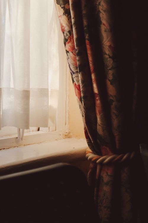 Free Retro floral curtain tied with rope beside an old window in Carnarvon, South Africa. Stock Photo
