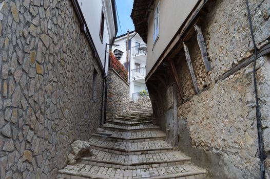 Quaint stone alley with stairs in Ohrid, showcasing rustic architecture and inviting ambiance.