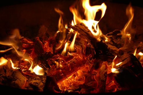 Free A detailed image capturing the warm, glowing flames of a campfire at night. Stock Photo