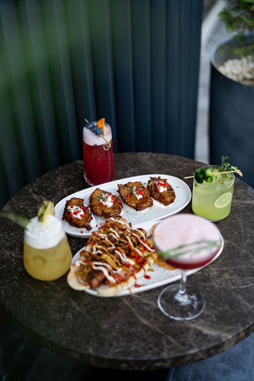 Free A stylish array of vibrant cocktails and gourmet appetizers elegantly arranged on a marble table. Stock Photo