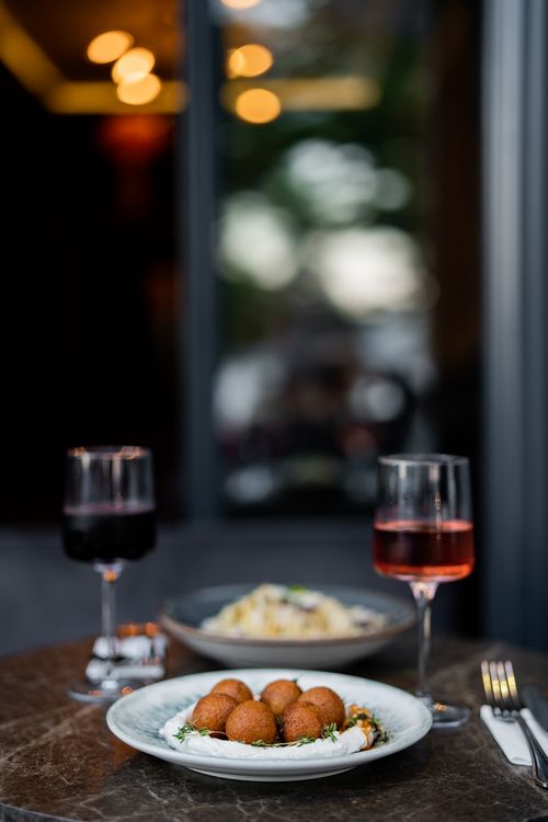 Free Elegant table setup with red and rose wine, appetizers and pasta in a cozy Istanbul restaurant. Stock Photo