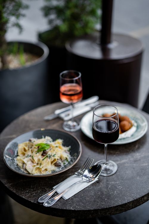 Free Elegant outdoor dining setup with wine, pasta, and appetizers in Istanbul. Stock Photo