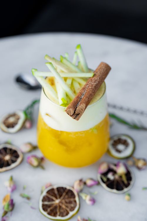 Free Elegant cocktail with apple and cinnamon garnish, perfect for a refreshing drink. Stock Photo