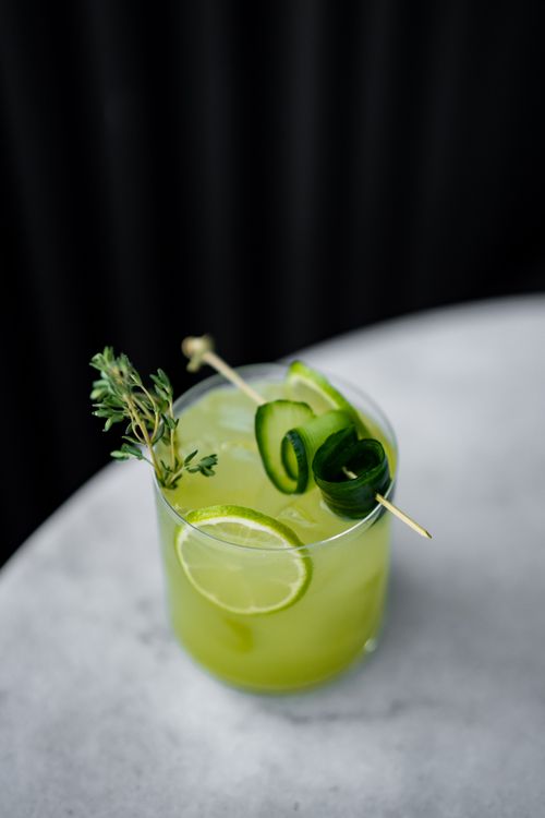 Free Vibrant green cocktail with lime and mint on a marble surface, perfect for a refreshing drink. Stock Photo