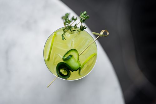 Free Elegant cocktail with cucumber garnish from above, captured in a stylish bar setting in Istanbul. Stock Photo