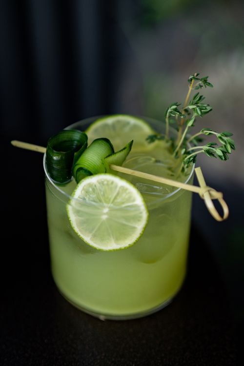 Free Vibrant lime and cucumber mocktail with herbal garnish in a glass for a refreshing taste. Stock Photo