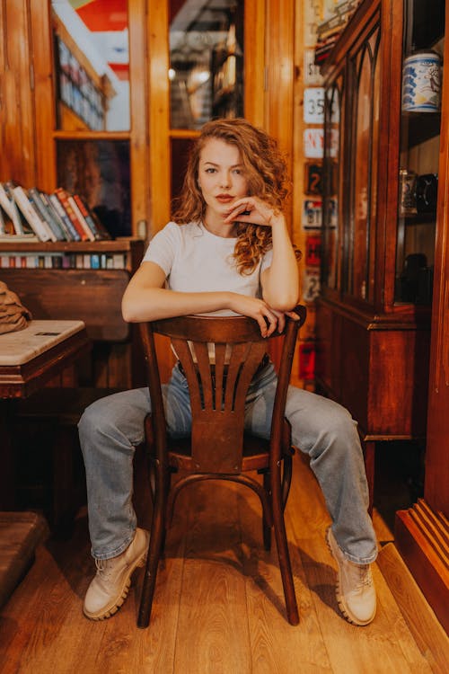 Woman Sitting in Wooden Chair 