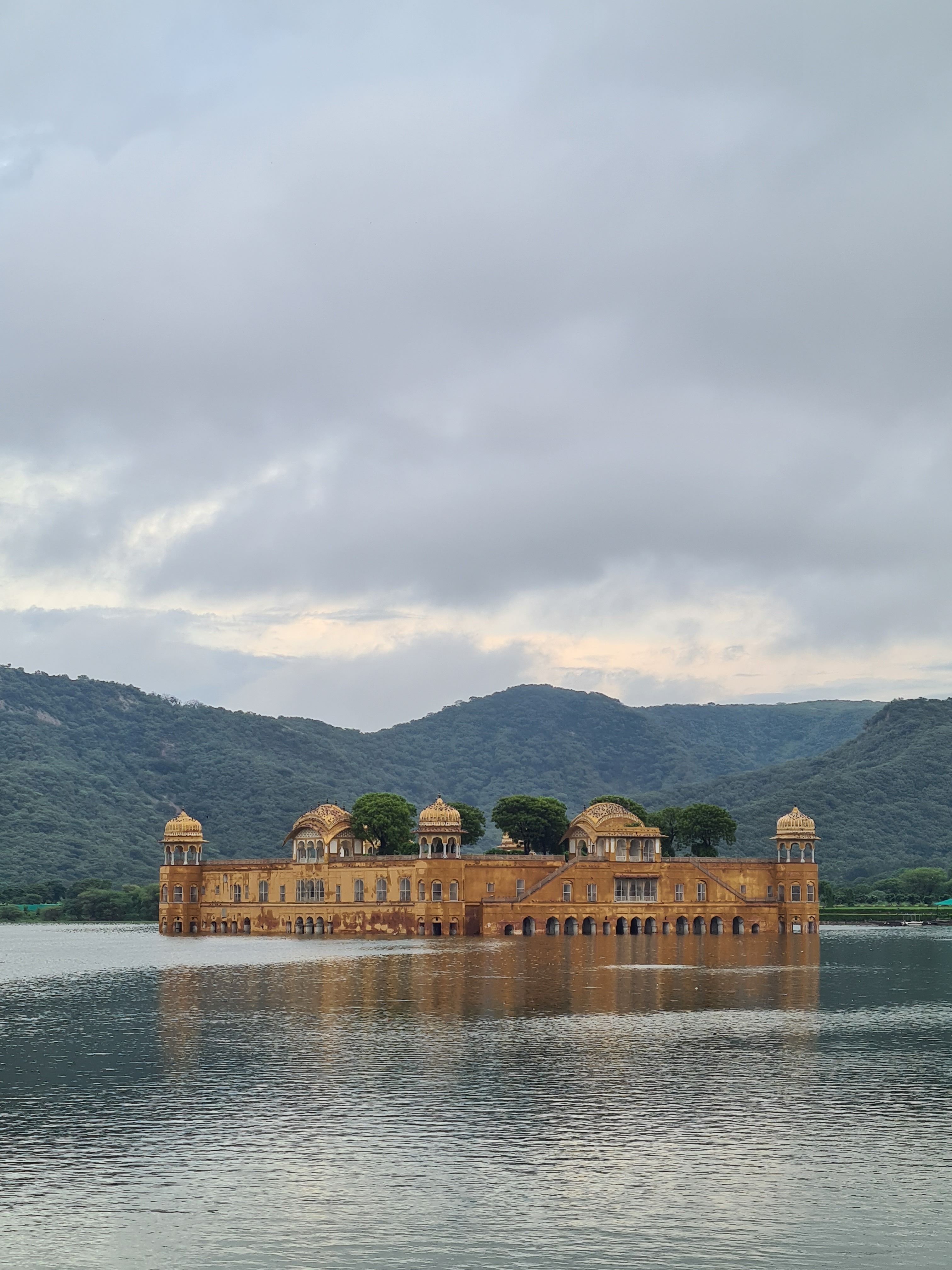 Capture the serene beauty of Jal Mahal reflecting on Man Sagar Lake during early morning in Jaipur.