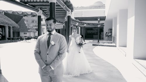 A bride and groom walking down the walkway