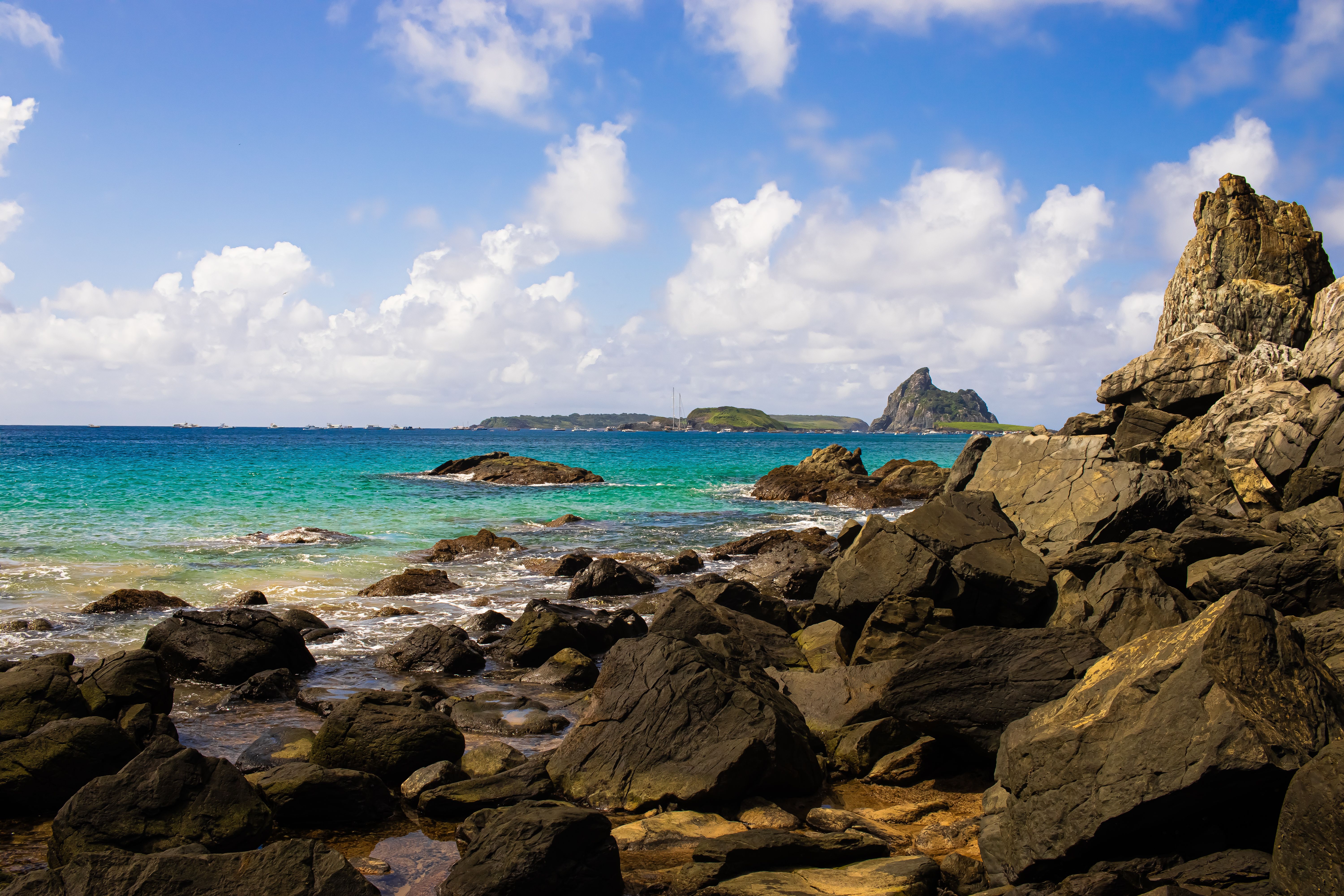 Beautiful rocky coastline with turquoise sea and clear sky, perfect for travel inspiration.