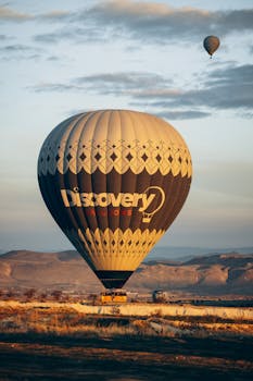 Stunning hot air balloon discovery at sunrise over Cappadocia's unique landscape in Türkiye.